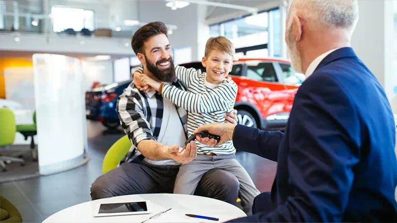 Father an son in a car showroom