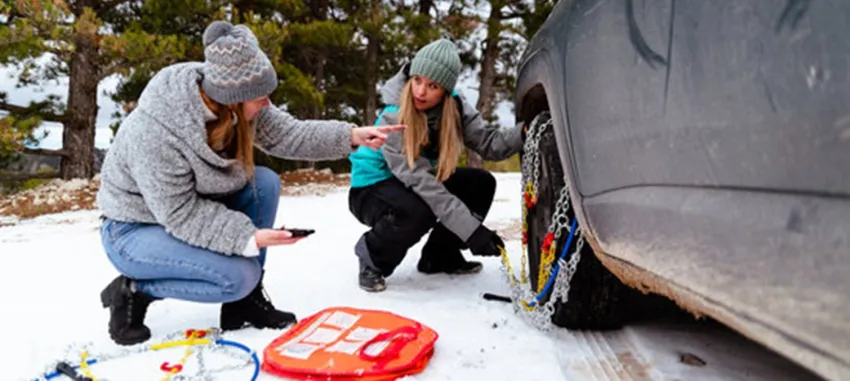 Putting snow chains on a tire