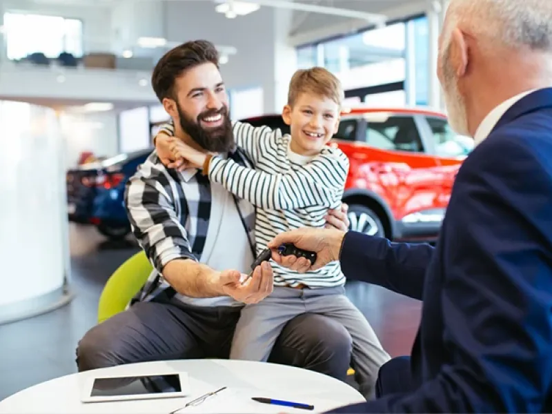 Father an son in a car showroom