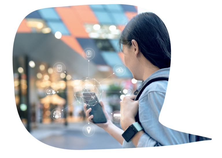 Woman with backpack walking in a shopping area while checking her phone for messages